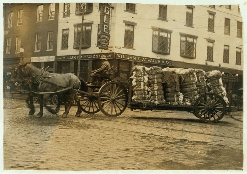 Bales of cotton going to the mill. Location Fall River, Massachusetts 